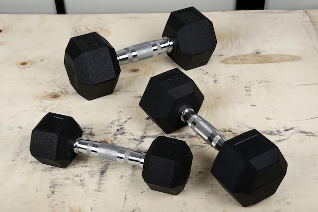 The metal dumbbells on the floor.