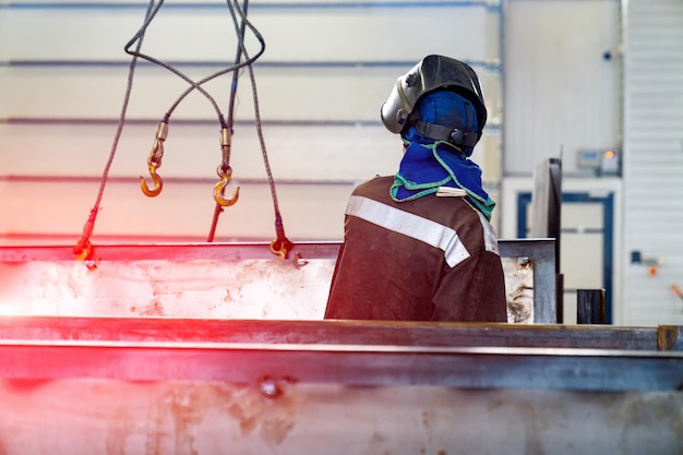 Metal factory worker in suit working Worker in protective hat in factory