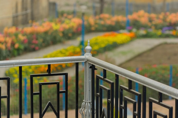 Photo metal fence by railing at park