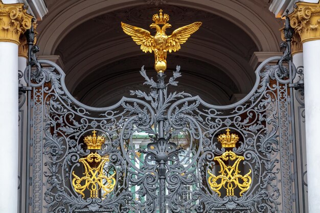 A metal gate with a gold eagle on top of it.