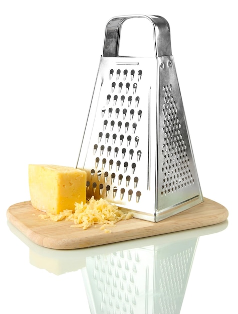 Metal grater and cheese on cutting board isolated on white