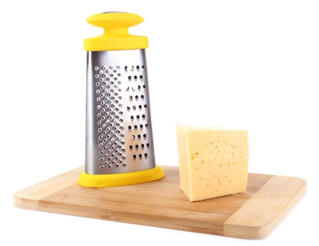 Metal grater and cheese isolated on white