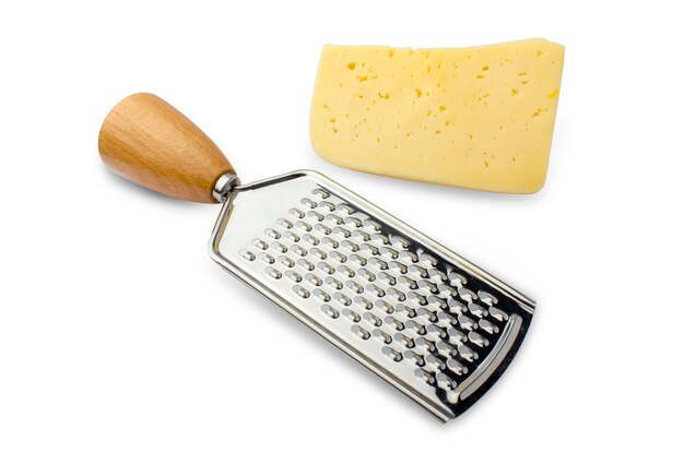 Metal grater with a wooden handle and a piece of hard cheese on white