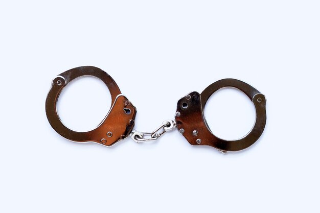 Photo metal handcuffs on white background.