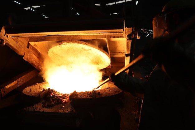 Metal industry work pouring molten metal