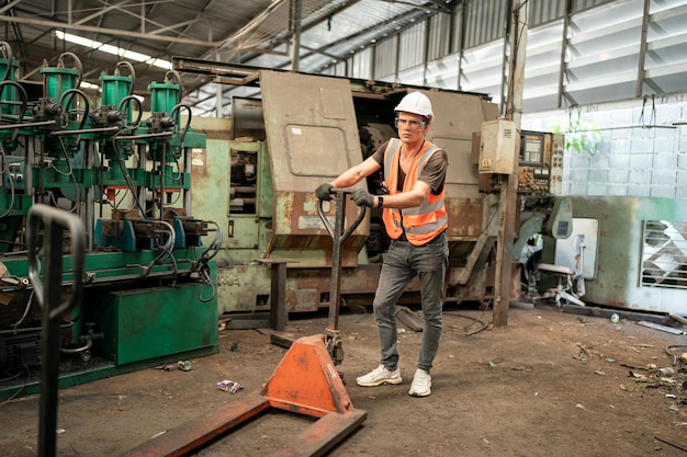 Metal industry worker at factory in work wear