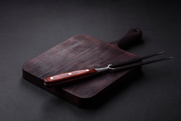 Metal kitchen fork on a dark textured concrete background Cutlery preparation for dinner