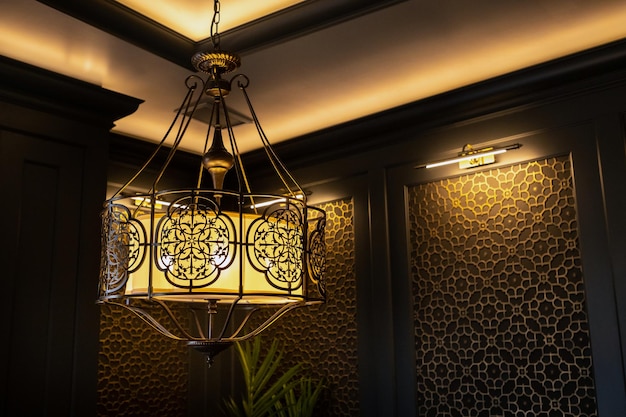 metal lamp in oriental style on the ceiling of the interior