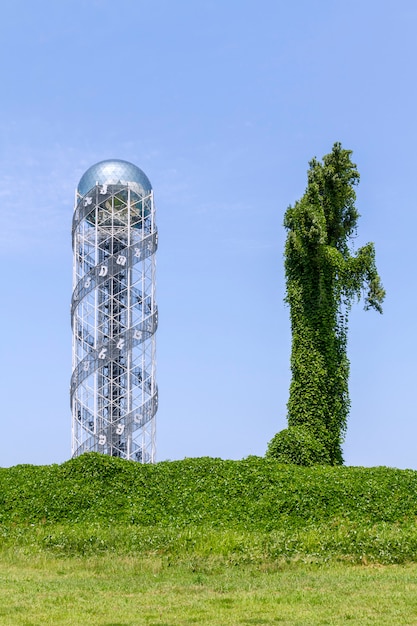 Metal and leaves towers on a green field