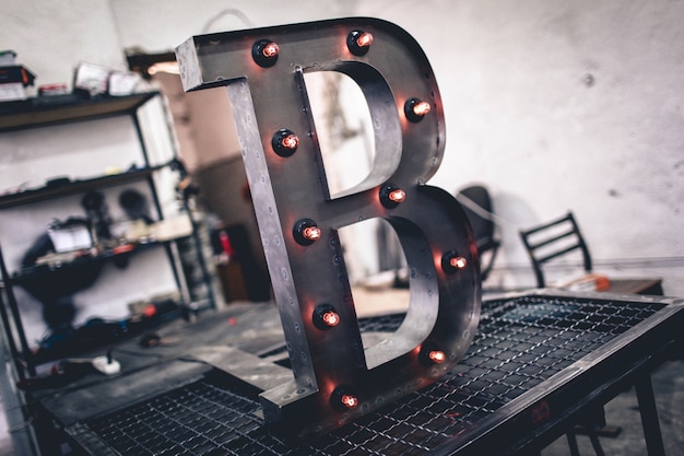 Metal letter b with led light bulbs isolated