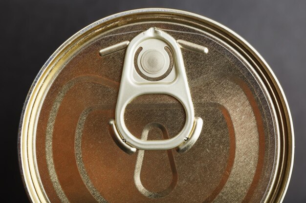 Metal lid with a ring from a tin can Top view, close-up