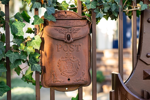 Metal mailbox in vintage style on the gate of the house