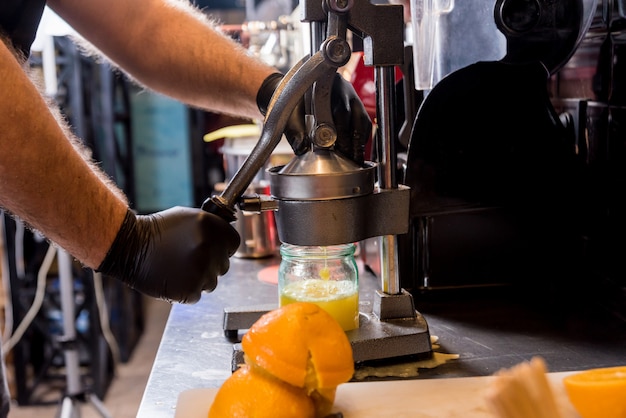 Metal manual juicer. Preparation of freshly squeezed orange juice