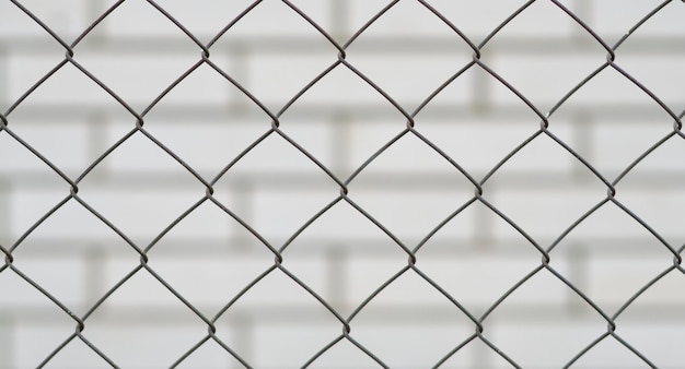 metal mesh and a brick wall behind it