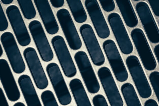 Metal mesh with rectangular perforation with rounded edges.