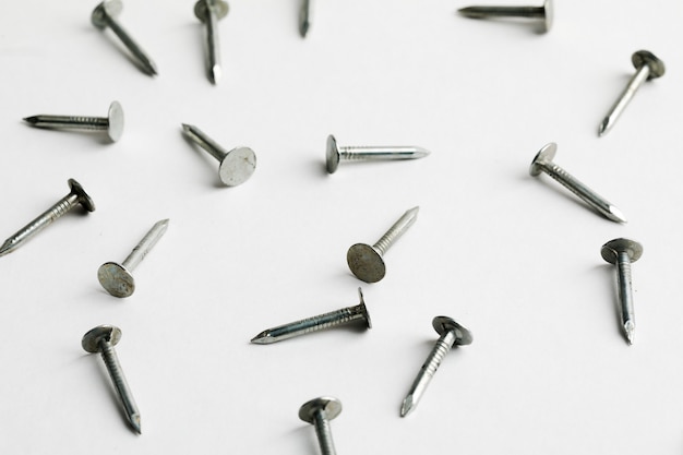 Metal nails close up, lots of nails on a white background.