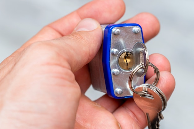 Metal padlock in the hand with keys