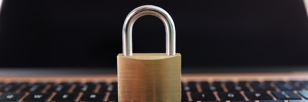 Metal padlock on laptop keyboard closeup concept of cyber security antivirus and electronic