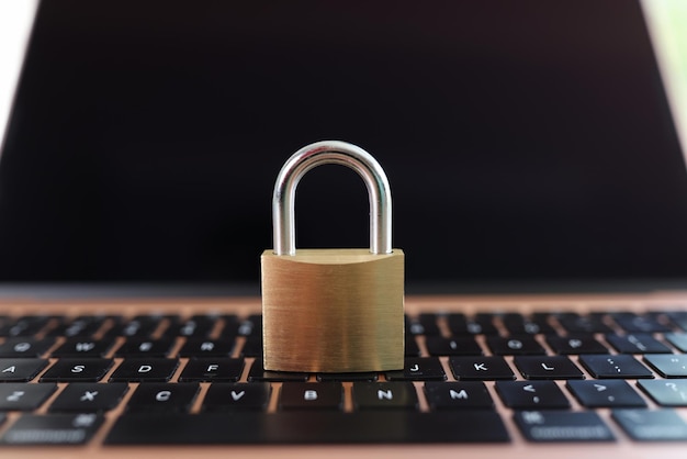 Metal padlock on laptop keyboard closeup