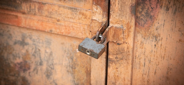 Metal padlock on the metal door