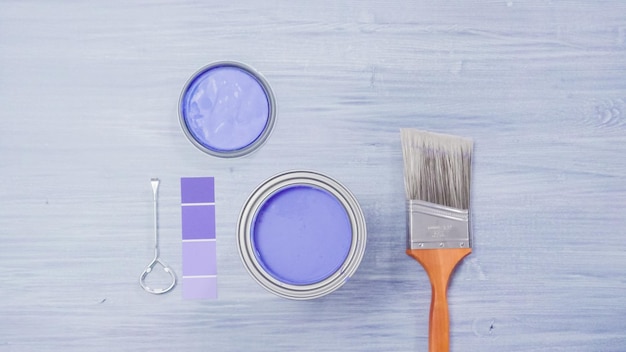 Photo metal paint can with purple paint and paint swatches.