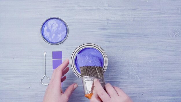 Metal paint can with purple paint and paint swatches