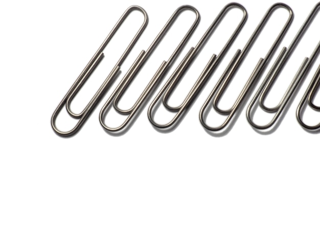 Metal paper clips on a white background office supplies isolated