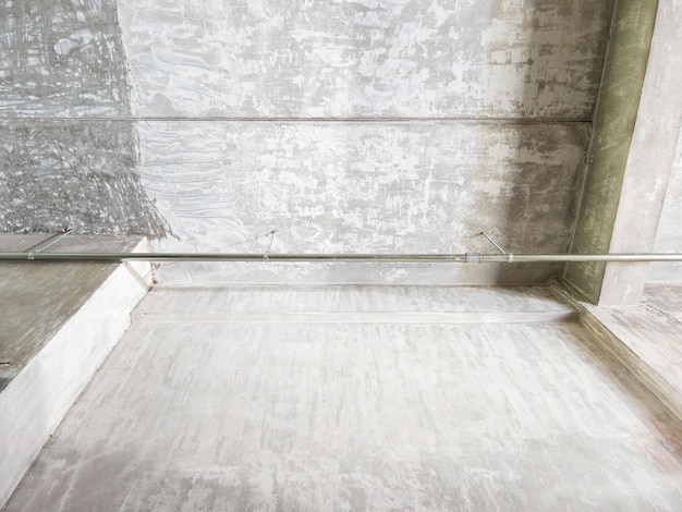 The metal pipe is hanging along the ceiling of the modern house