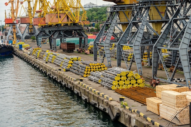 Metal pipes and stacks of timber ready for shipment in sea port
in ukraine