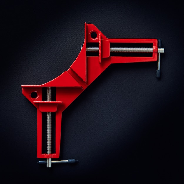 Metal red corner clamp-on dark background