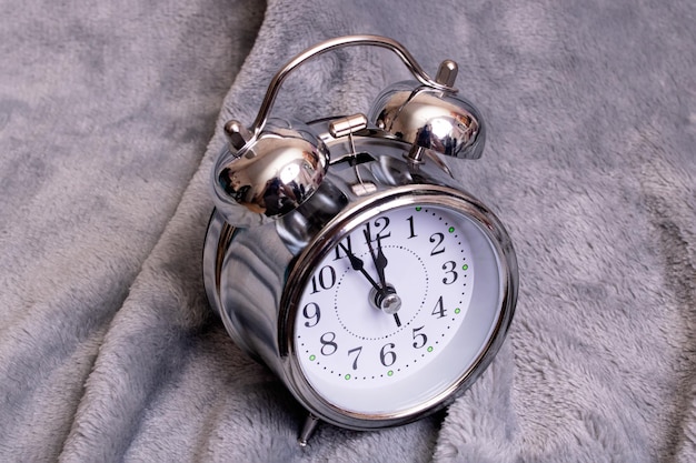 Metal retro alarm clock on gray background
