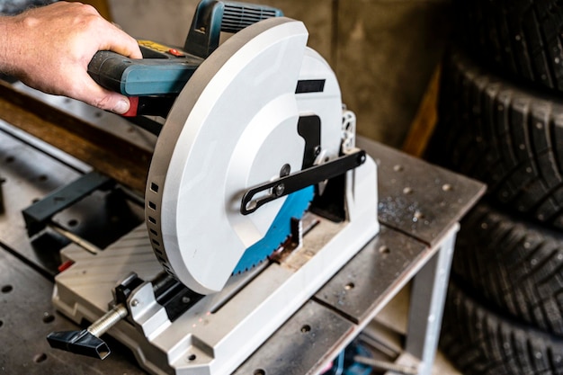 Photo metal saw with tool cutting disc makes a cut