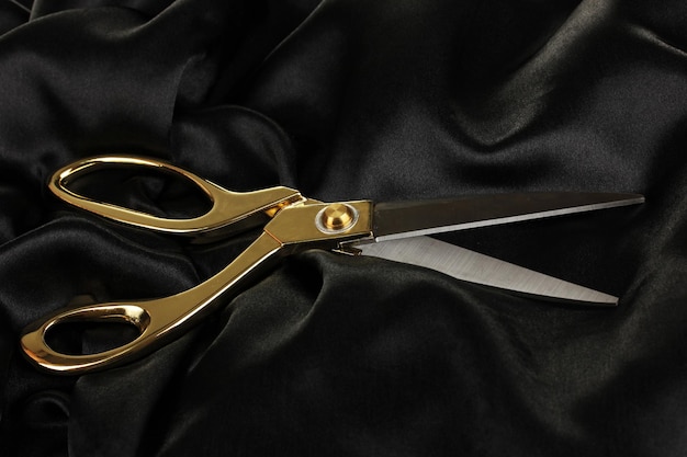 Photo metal scissors on black fabric