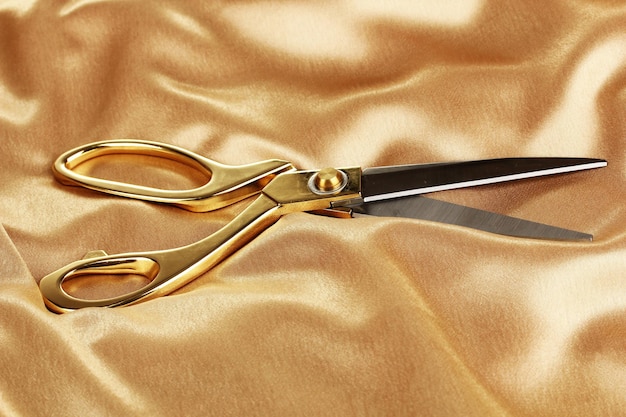 Photo metal scissors on gold fabric