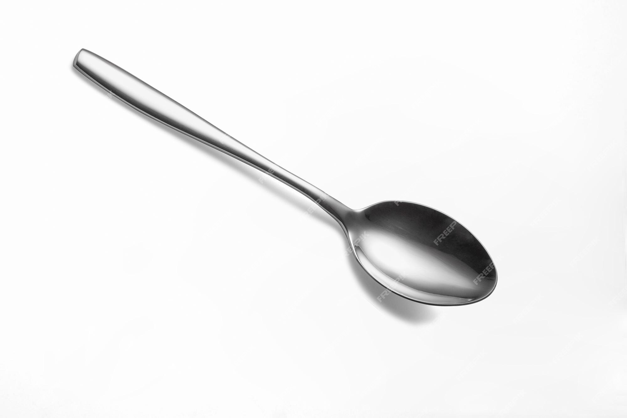 Clean shiny metal spoon isolated on white. Stainless steel small kitchen  dessert teaspoon cut close up. Tablespoon. Kitchen utensils concept. Set of  realistic spoons from different points of view Stock Photo by ©