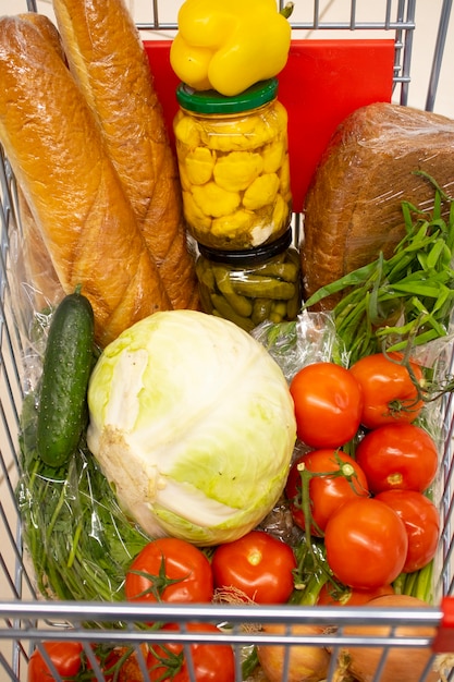 Metal shopping trolley filled with products top view