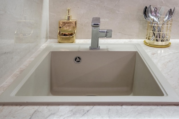 Metal sink faucet in a modern kitchen