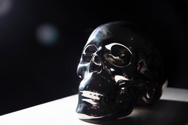 Metal skull on black background