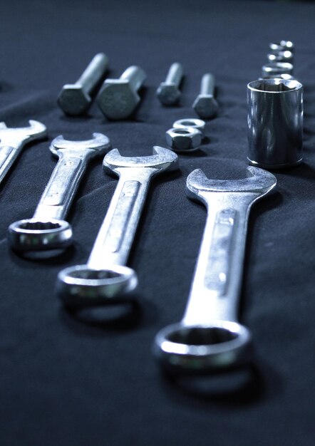 Photo metal socket wrench bits screw bolts and steel wrenches in a size comparison vertical stock photo