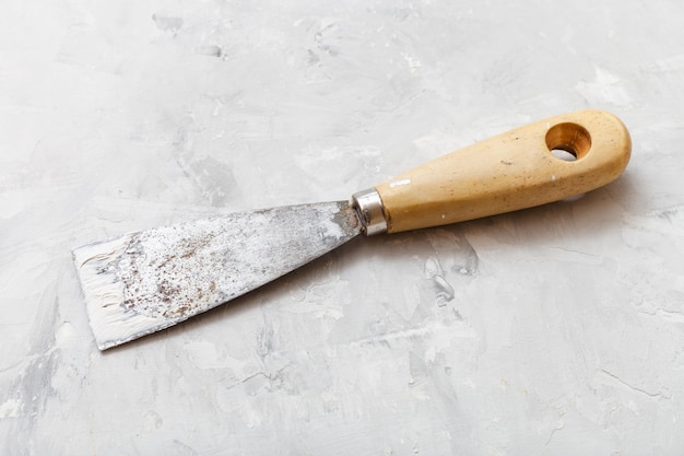 Metal spatula with wooden handle on floor