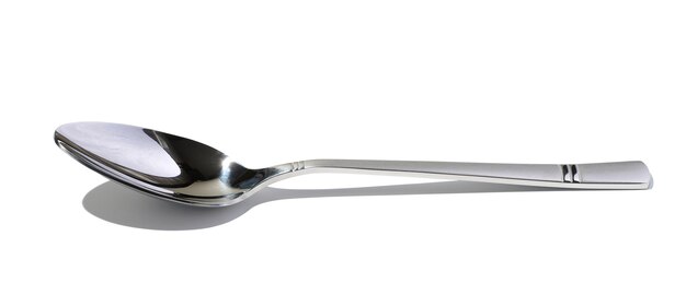 Metal spoon for soup on a white isolated background