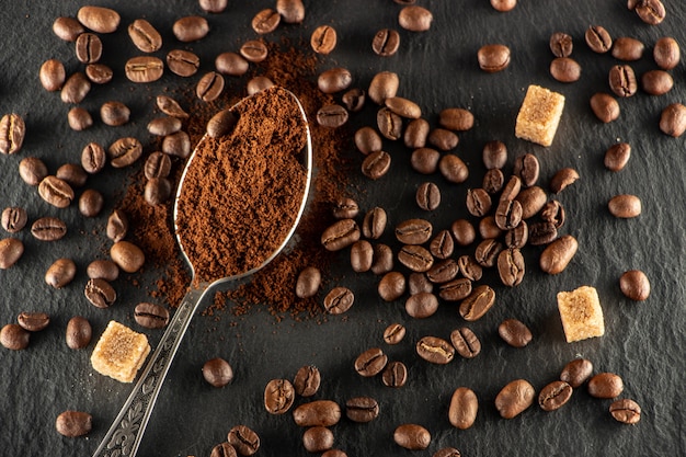 Metal spoon with ground coffee