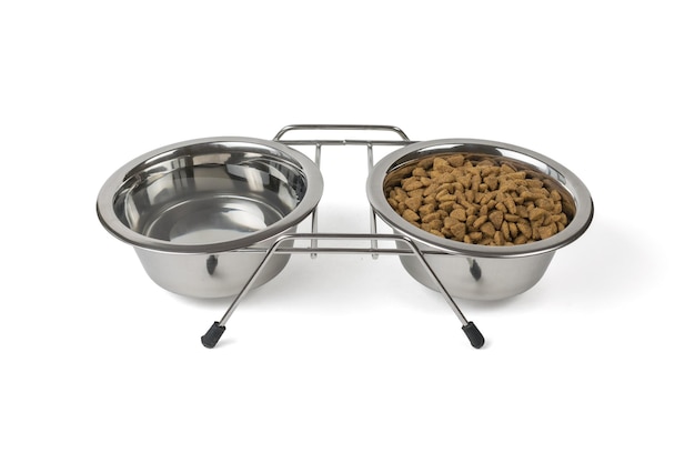 Metal stand with a bowl of water and a bowl of dry food isolated on a white background.