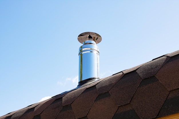 Metal stove pipe on the roof closeup