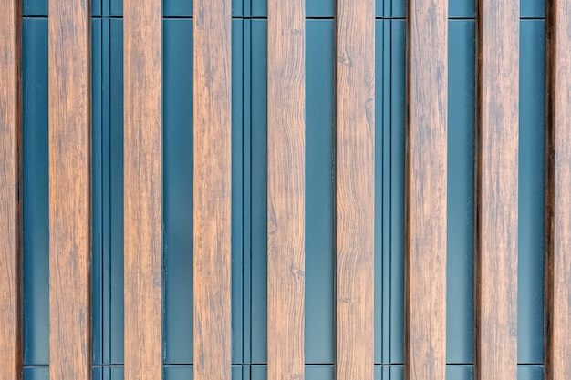 The metal surface of the wall is decorated with decorative wooden slats As a natural background