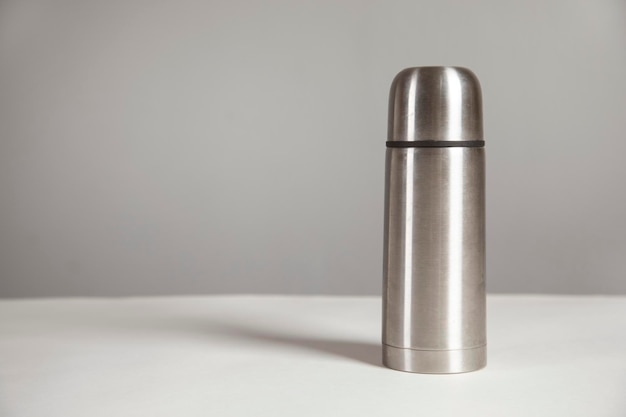 Metal thermos on a white background