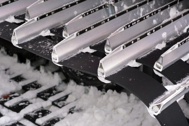 Metal tracks of a snowplow car in winter in the snow.