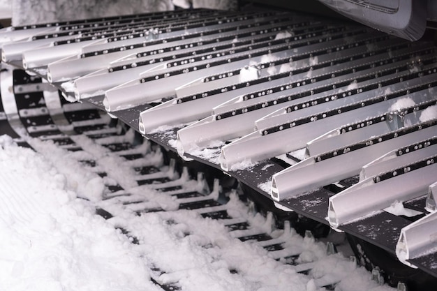 Metal tracks of a snowplow car in winter in the snow.