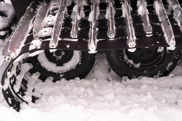 Metal tracks of a snowplow car in winter in the snow