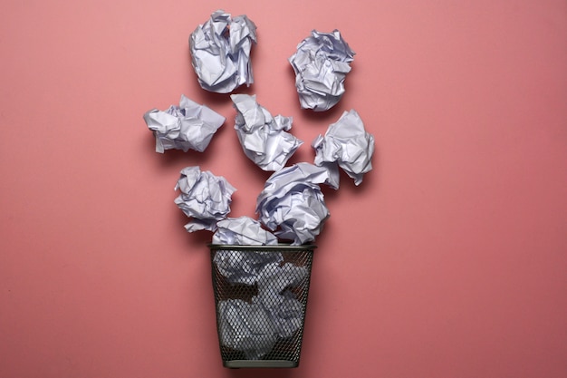 Metal trash bin with paper. Concept paper basket.